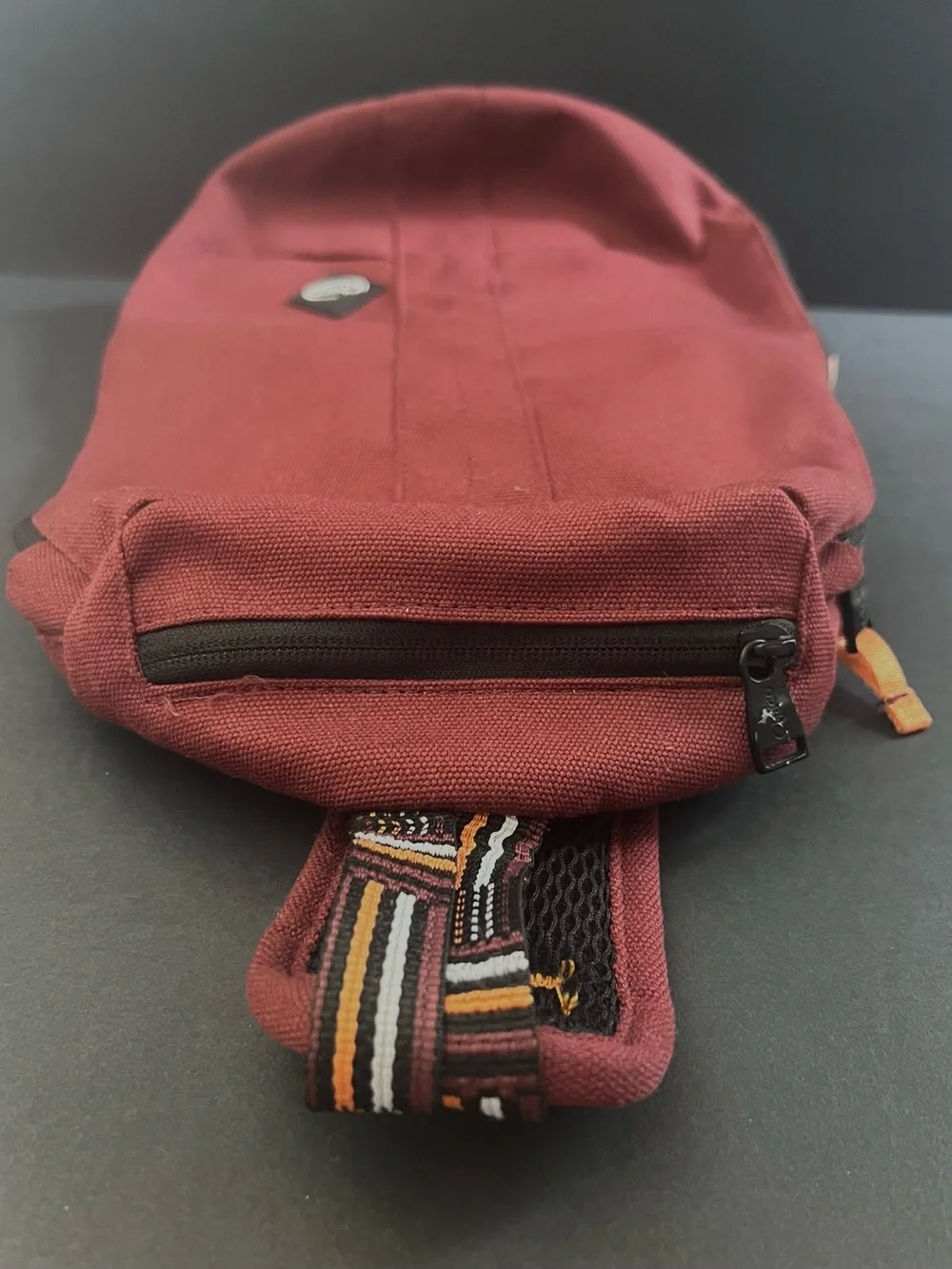 Chaco Men's Burgundy Red Sling Bag with Orange, Black and White Strap Detail